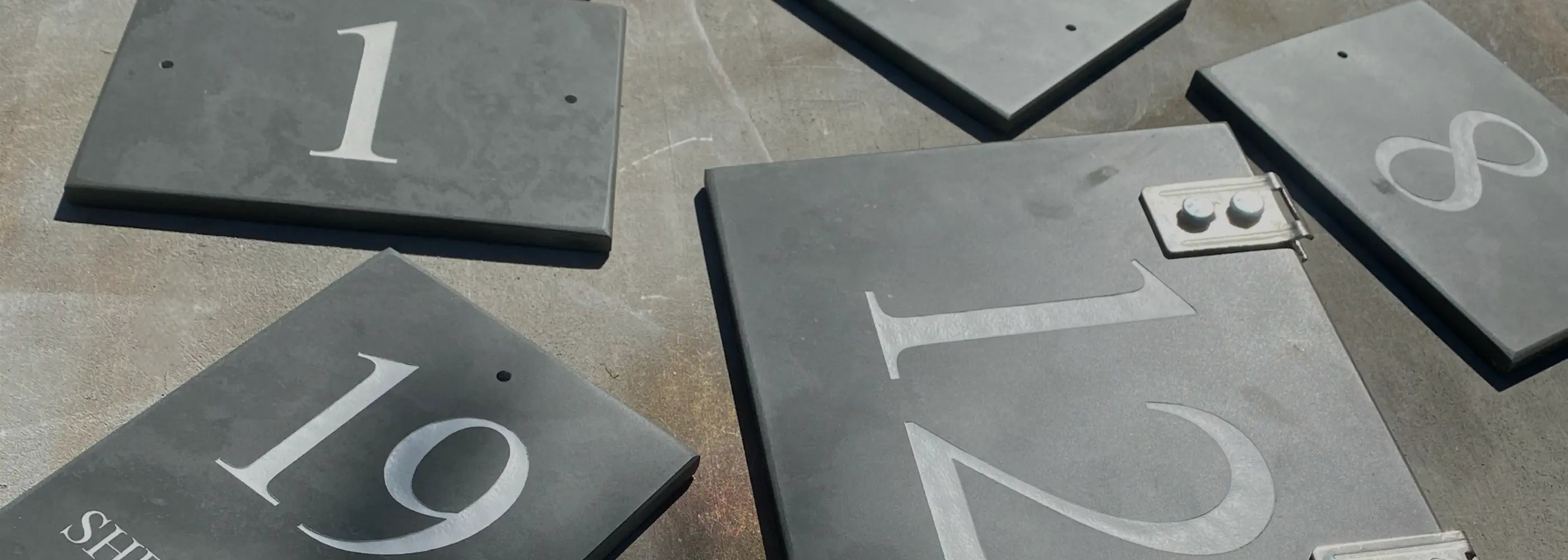 Set of stone house signs with numbers engraved on them