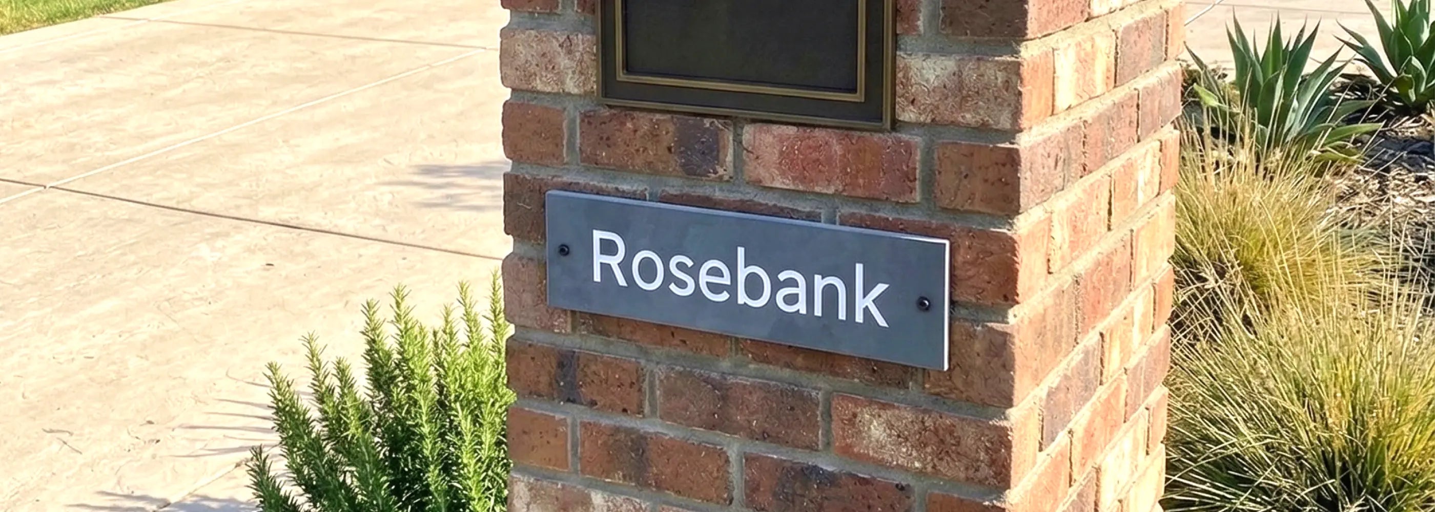 Brick wall with a mailbox and 'Rosebank' house sign