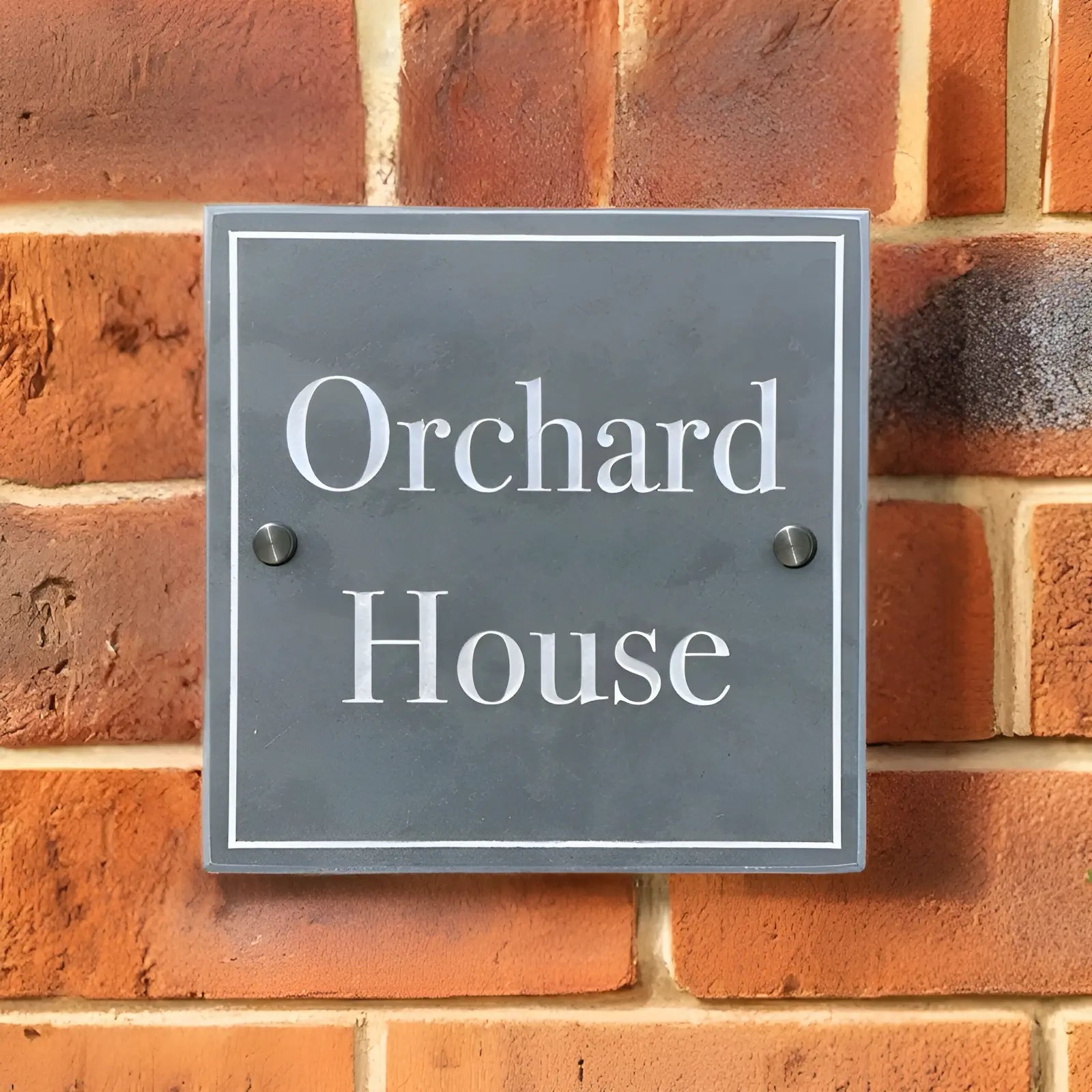 “Welsh slate house sign with ‘No. 8’ engraved in white, mounted on a red brick wall with two visible pre-drilled holes for mounting.”