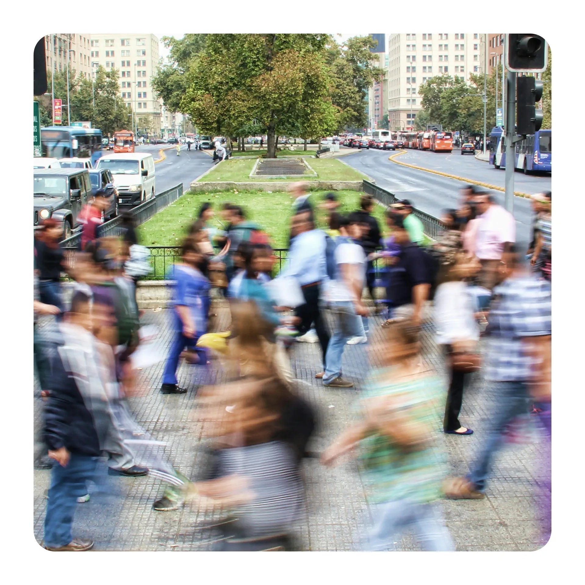 Blurred image of a busy city street with pedestrians and traffic.