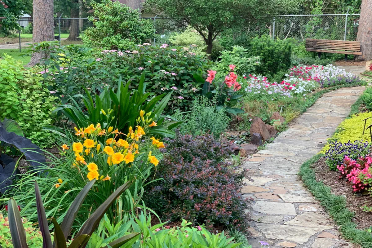 flower garden with stone slab pathway