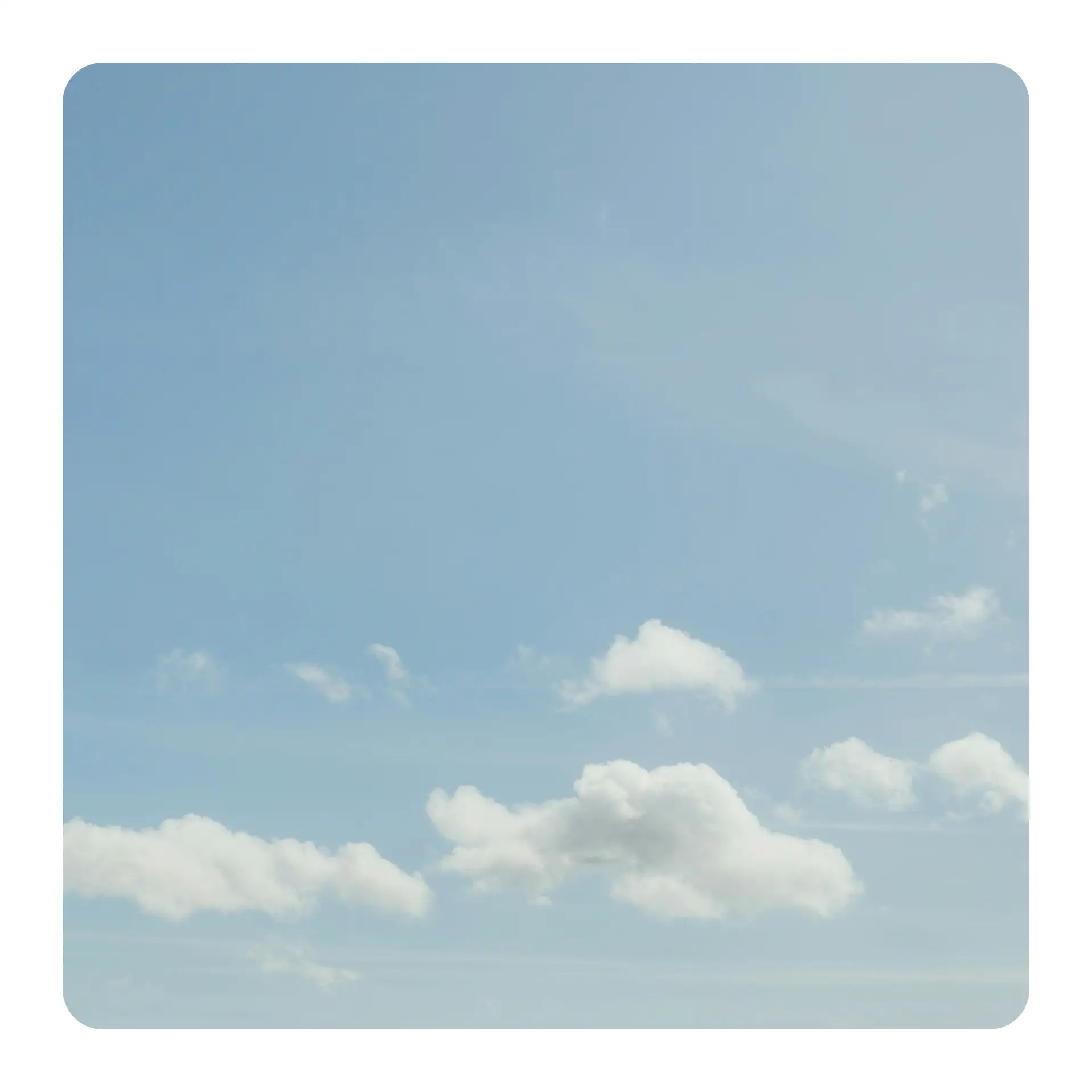 Clear blue sky with a few scattered clouds