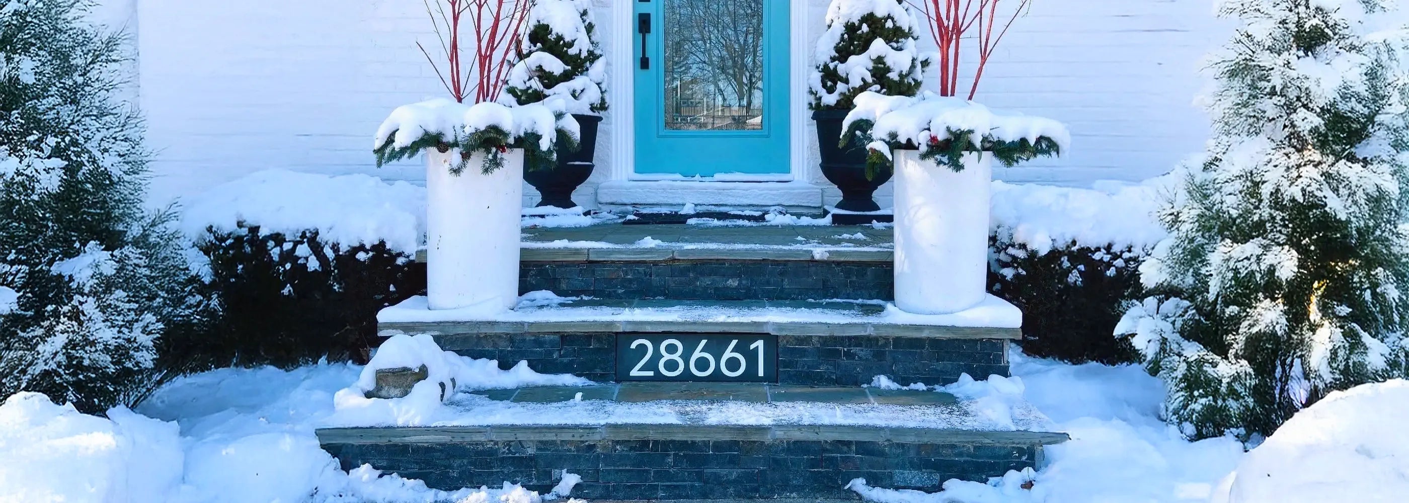House number '28661' on a snowy porch with columns.