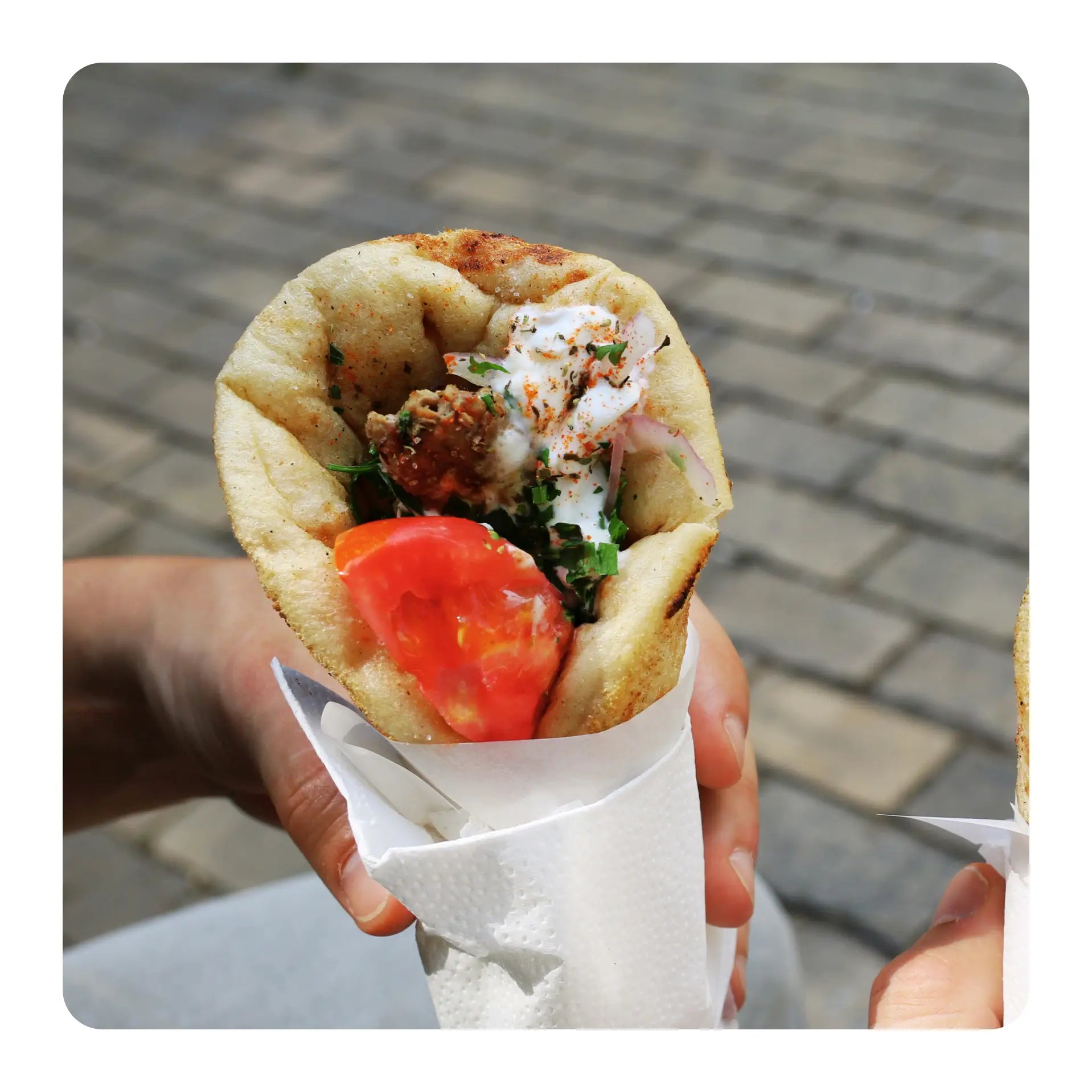 a greek pitta wrap/gyros with tomato and slaw