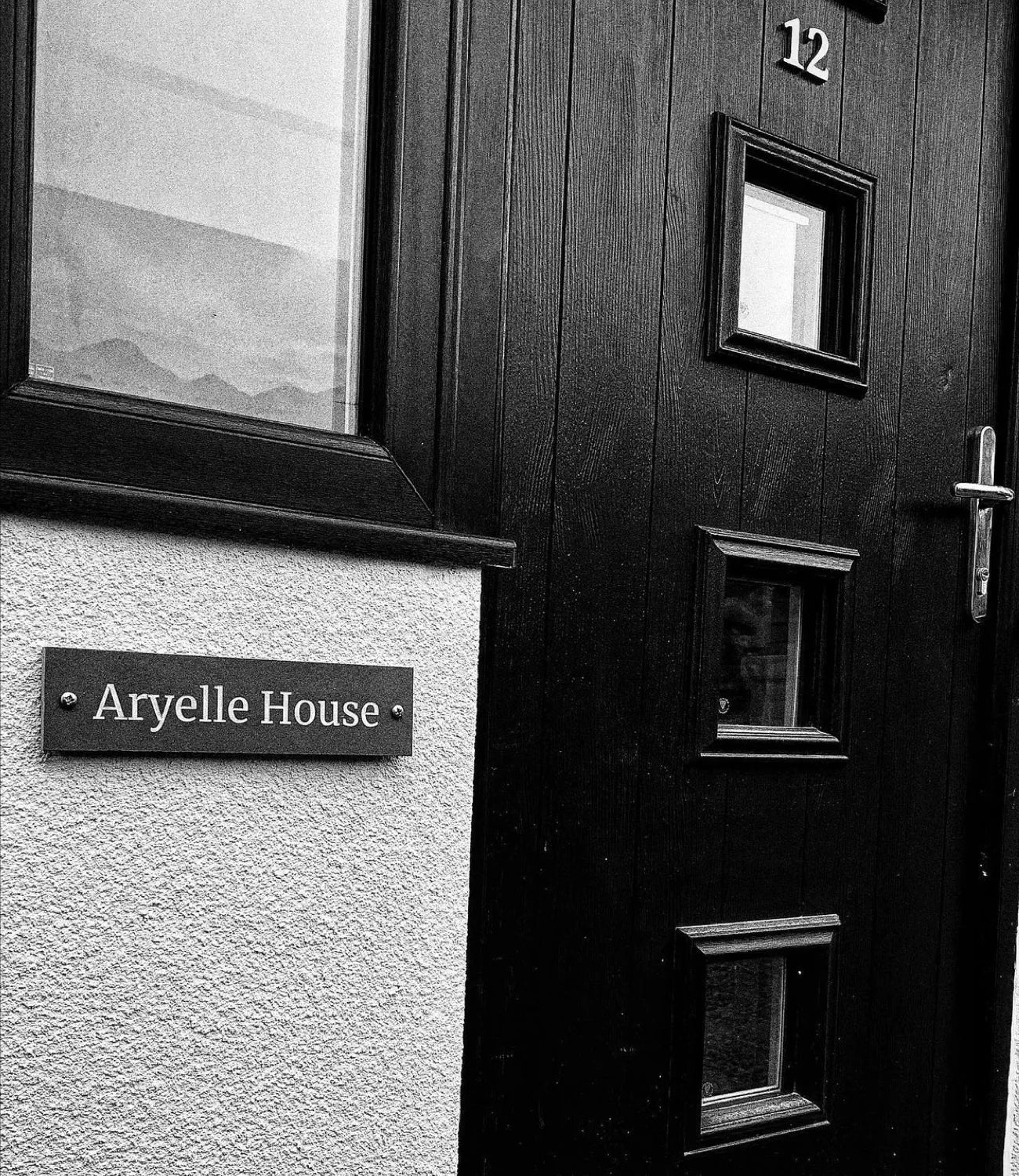 A collage showcasing various house signs, including slate designs mounted on brick, wood, and stone backgrounds, with clear, elegant text styles.