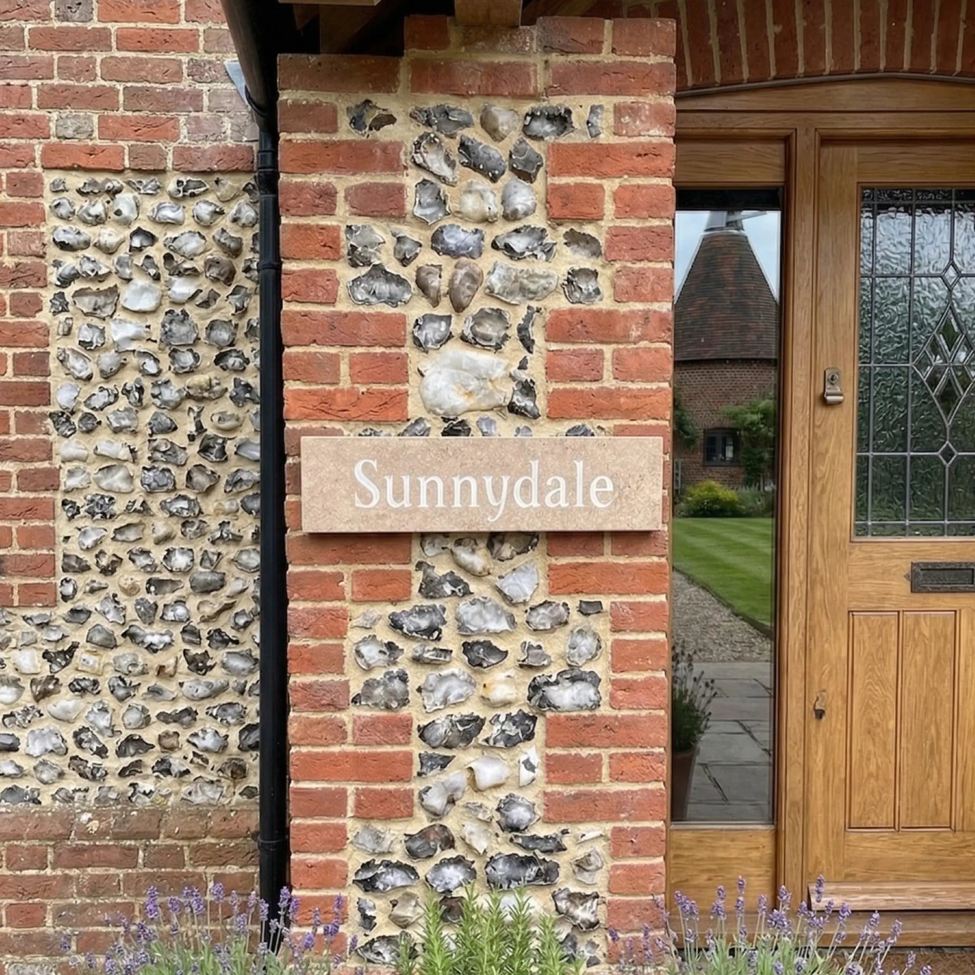 a limestone sign on a brick wall reading Sunnydale in white