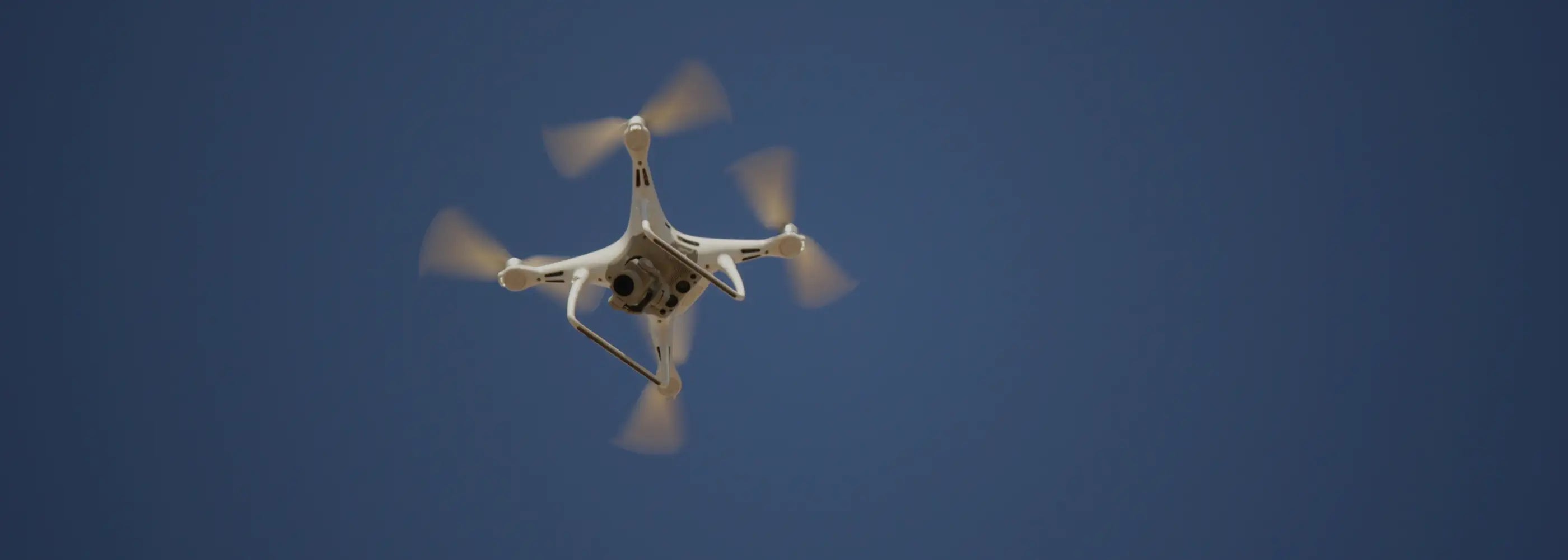 Drone flying against a clear blue sky