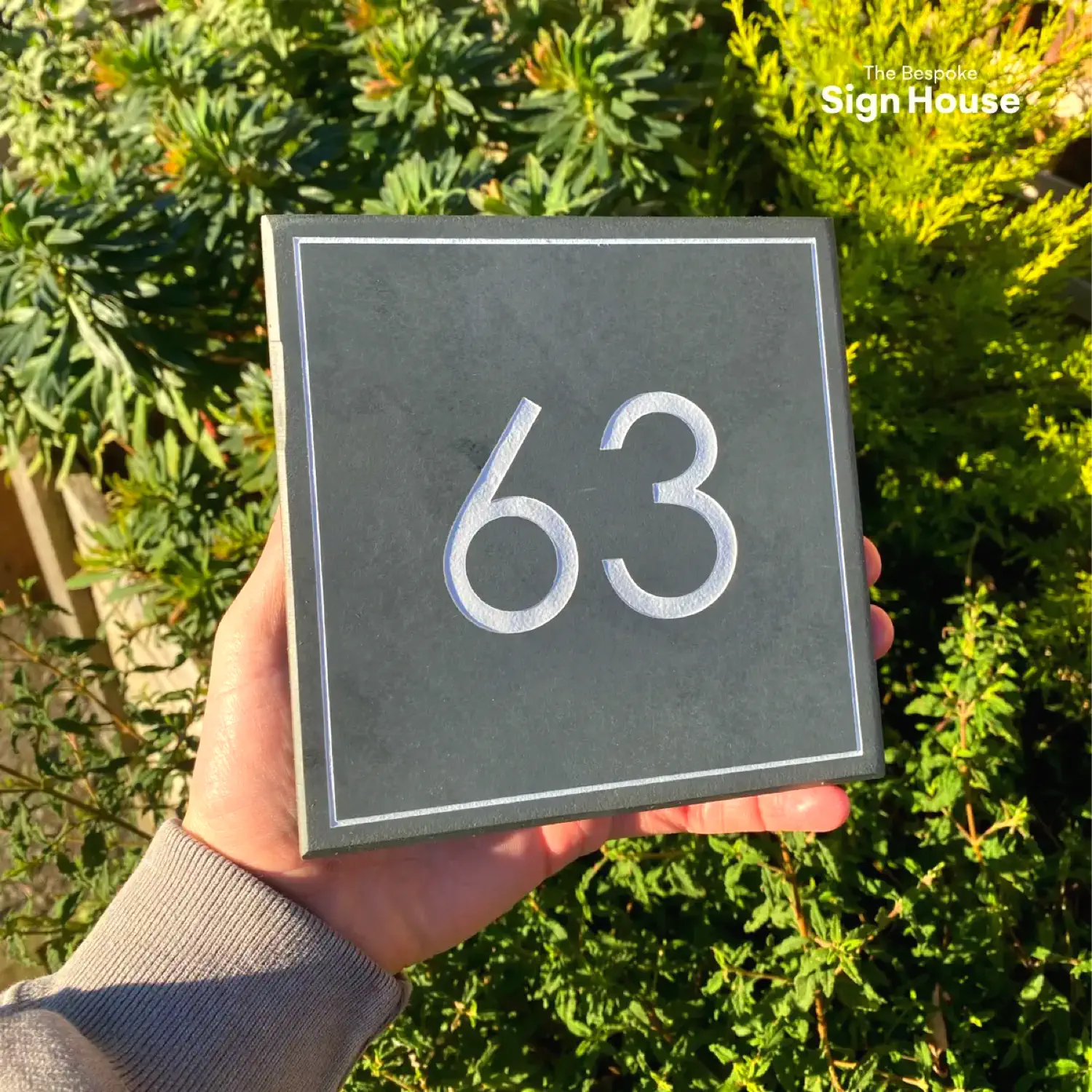 House number sign with number '63' stylised in a white box