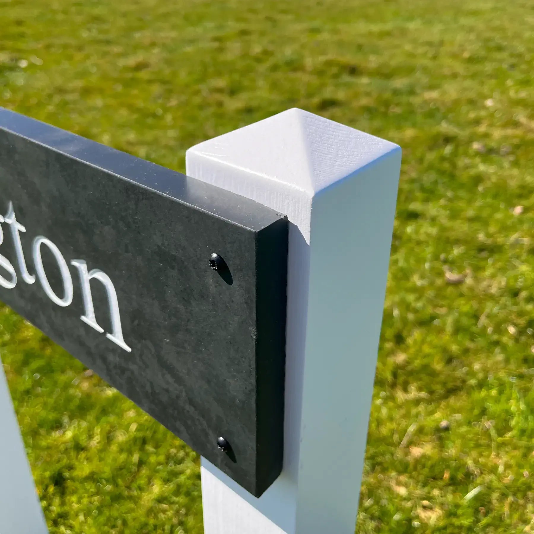 Close-up of a signpost on a grassy background