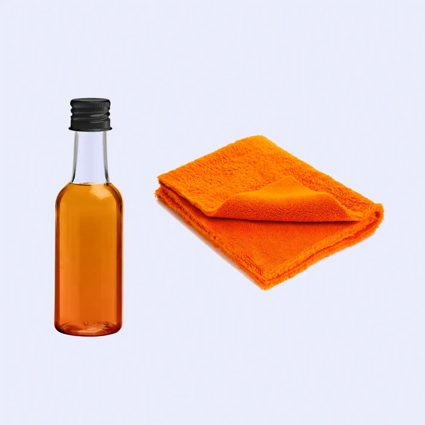 An image showing a bottle of slate oil next to a folded microfiber cloth, both placed on a slate surface, indicating their use in cleaning and maintaining the appearance of slate.