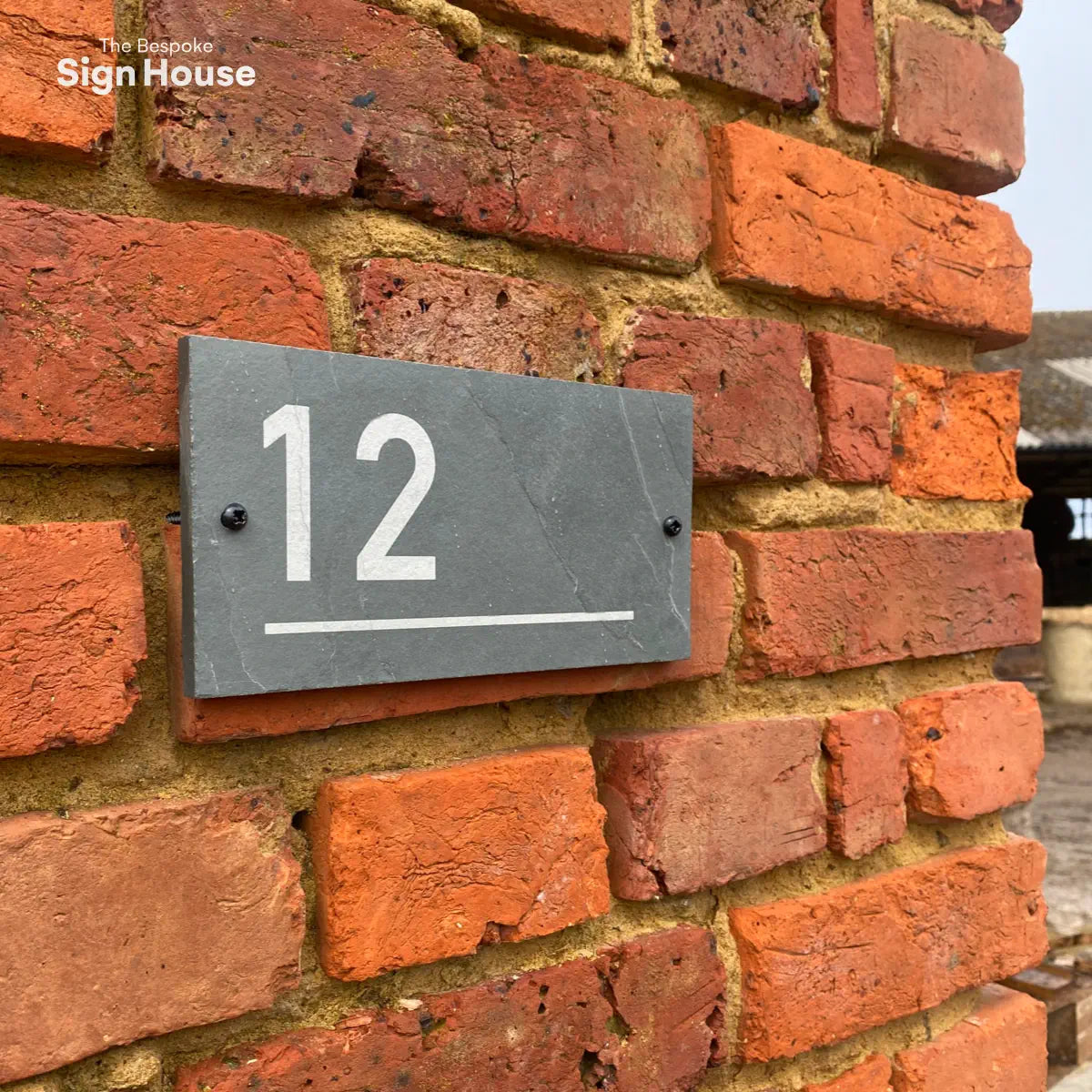 underlined slate door number sign
