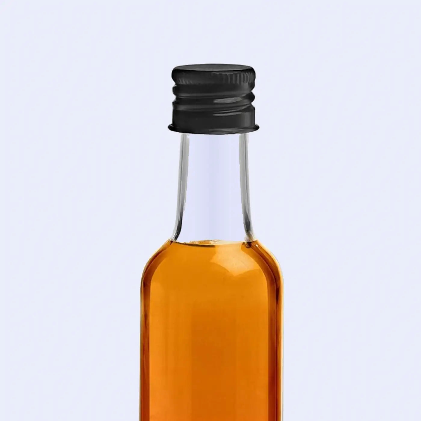 A close-up image of a bottle of Tableau Slate Oil with a dark label, placed on a slate surface, emphasizing its use for treating and maintaining the natural finish of slate materials.