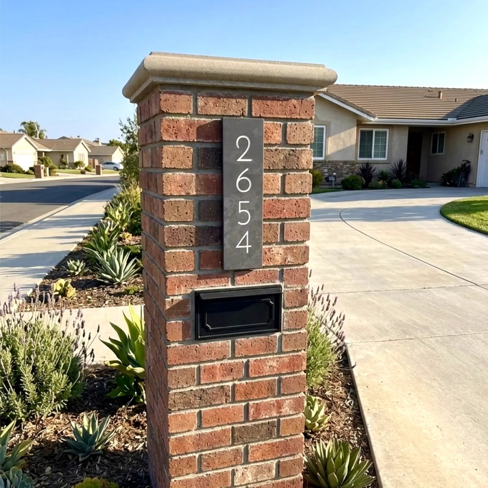 Brick column with address numbers and mailbox in a suburban setting