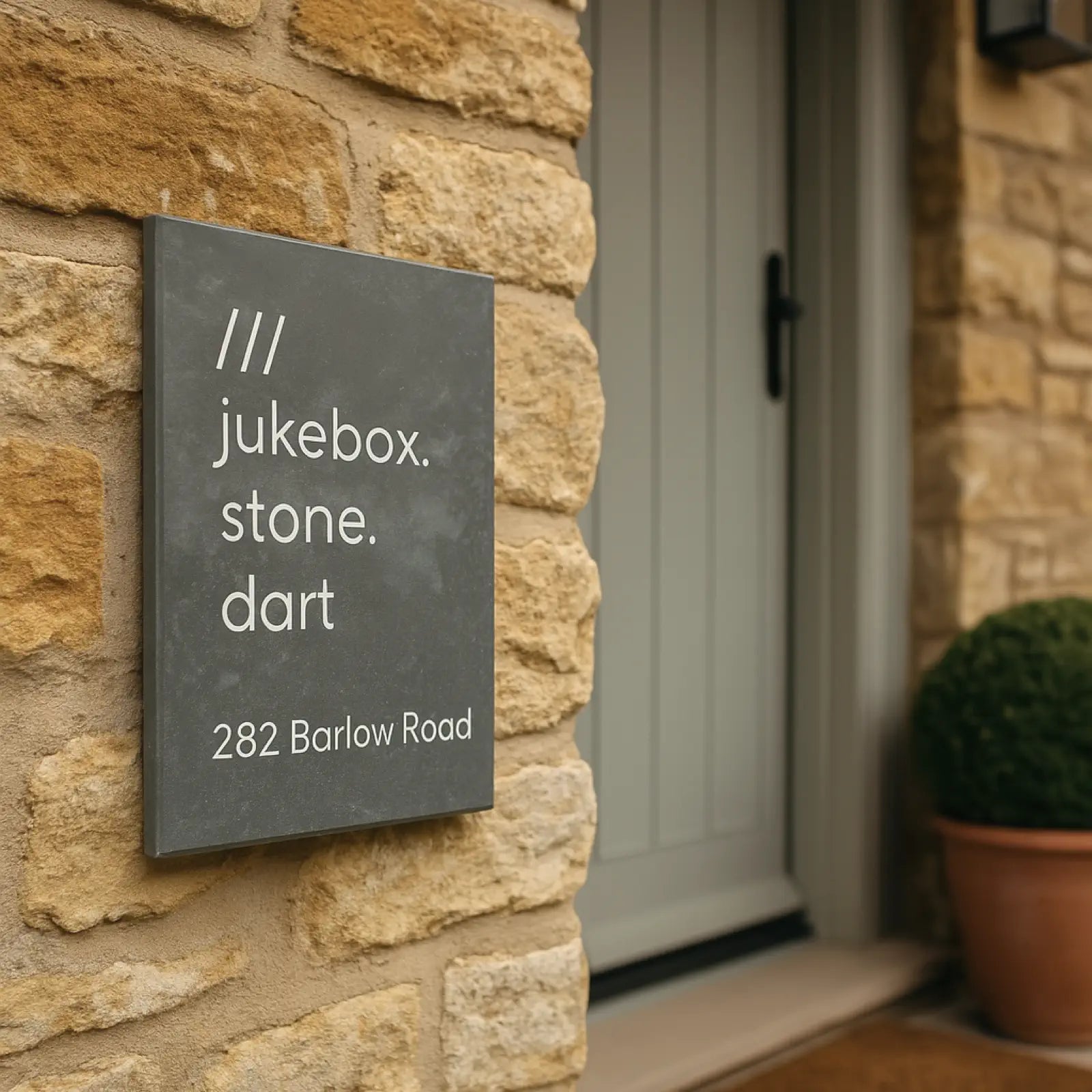 a simple slate sign with a specific what3words address engraved in white
