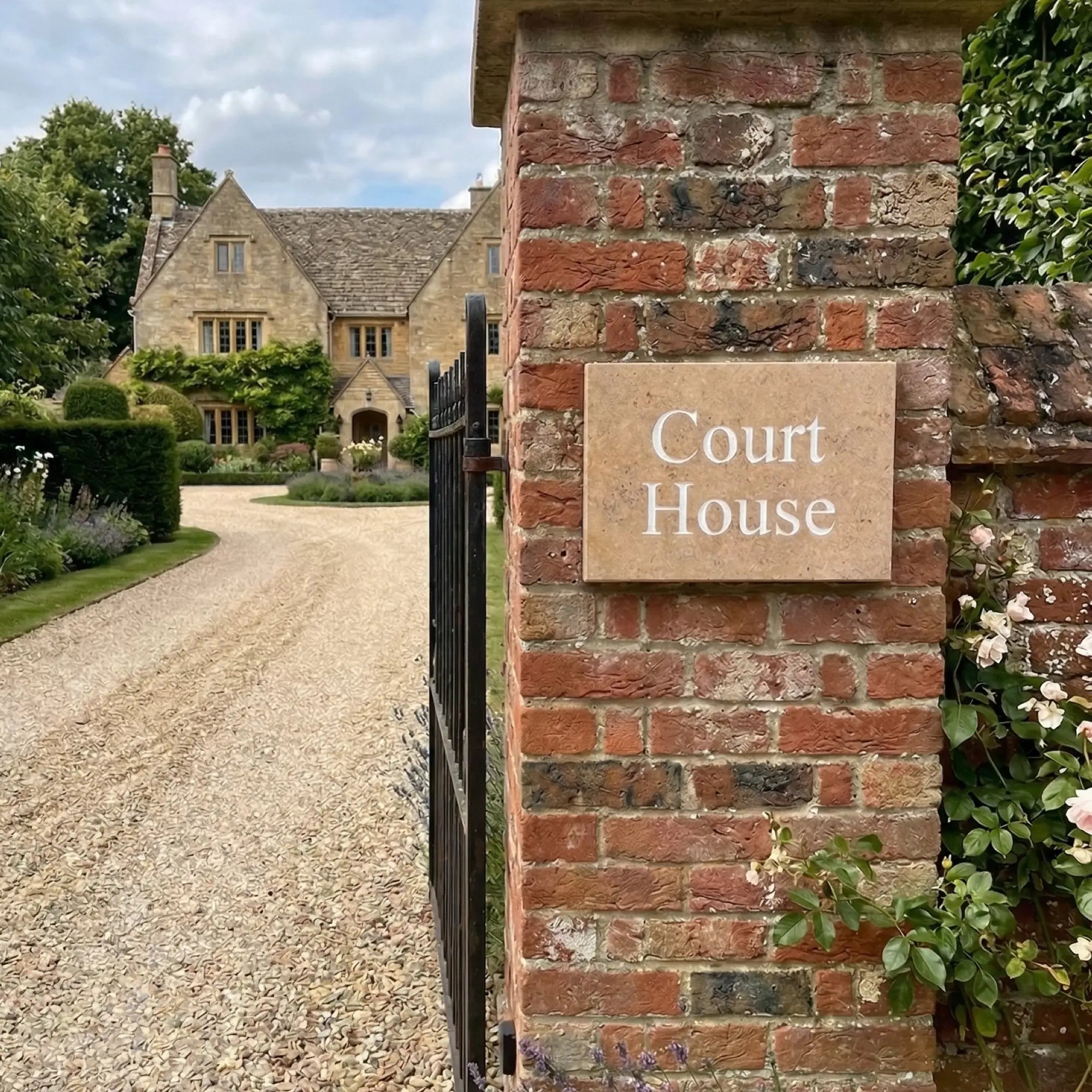 golden white limestone sign with 'DUNE VIEW' text on a stone wall