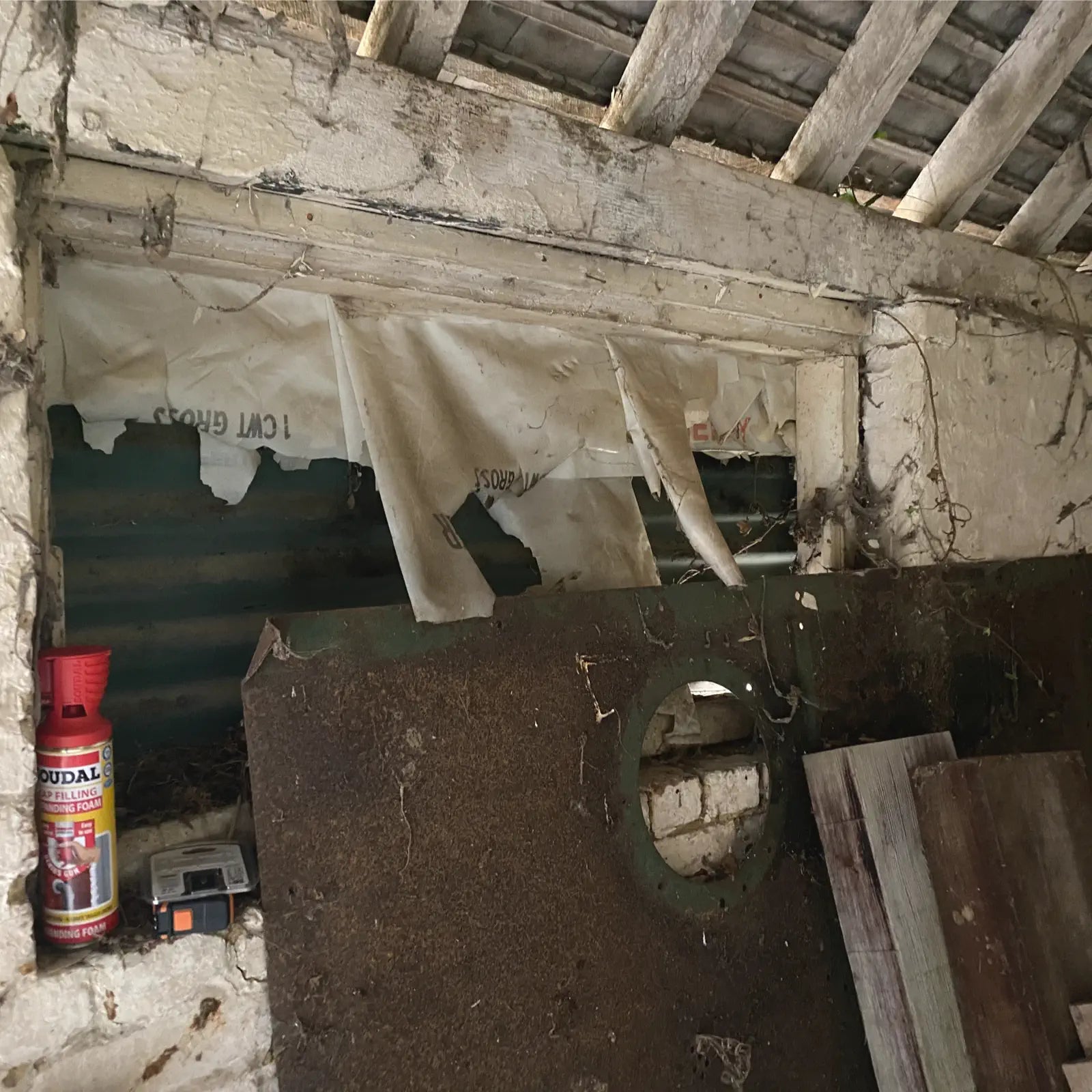 Old industrial setting with large metal component and protective covering