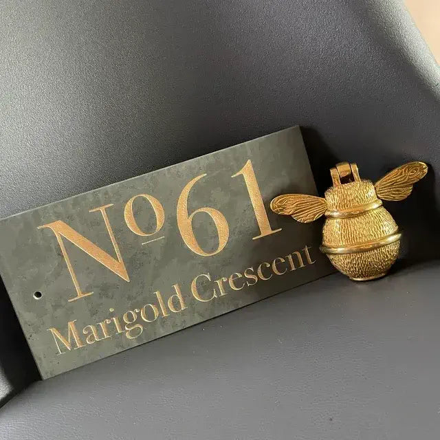 Gold bee door knocker and house sign