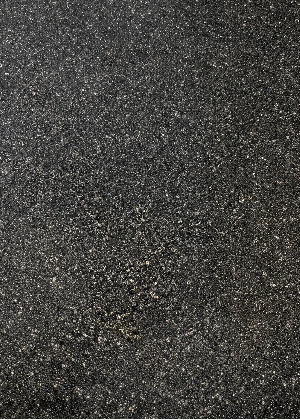 Dense granite stone texture close-up showing quartz and feldspar minerals, used for architectural house signs.