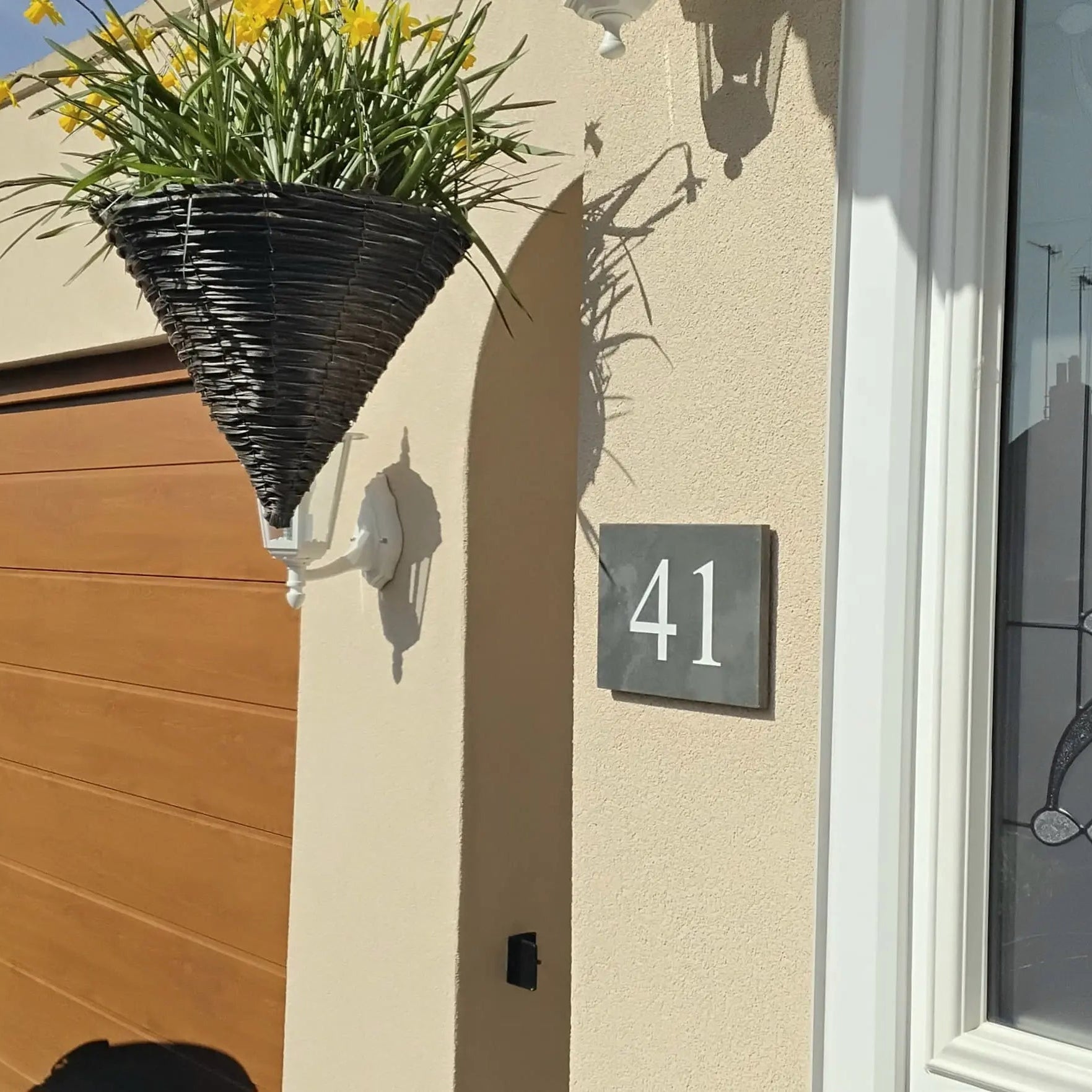 A picture of a slate house number plaque on a US home