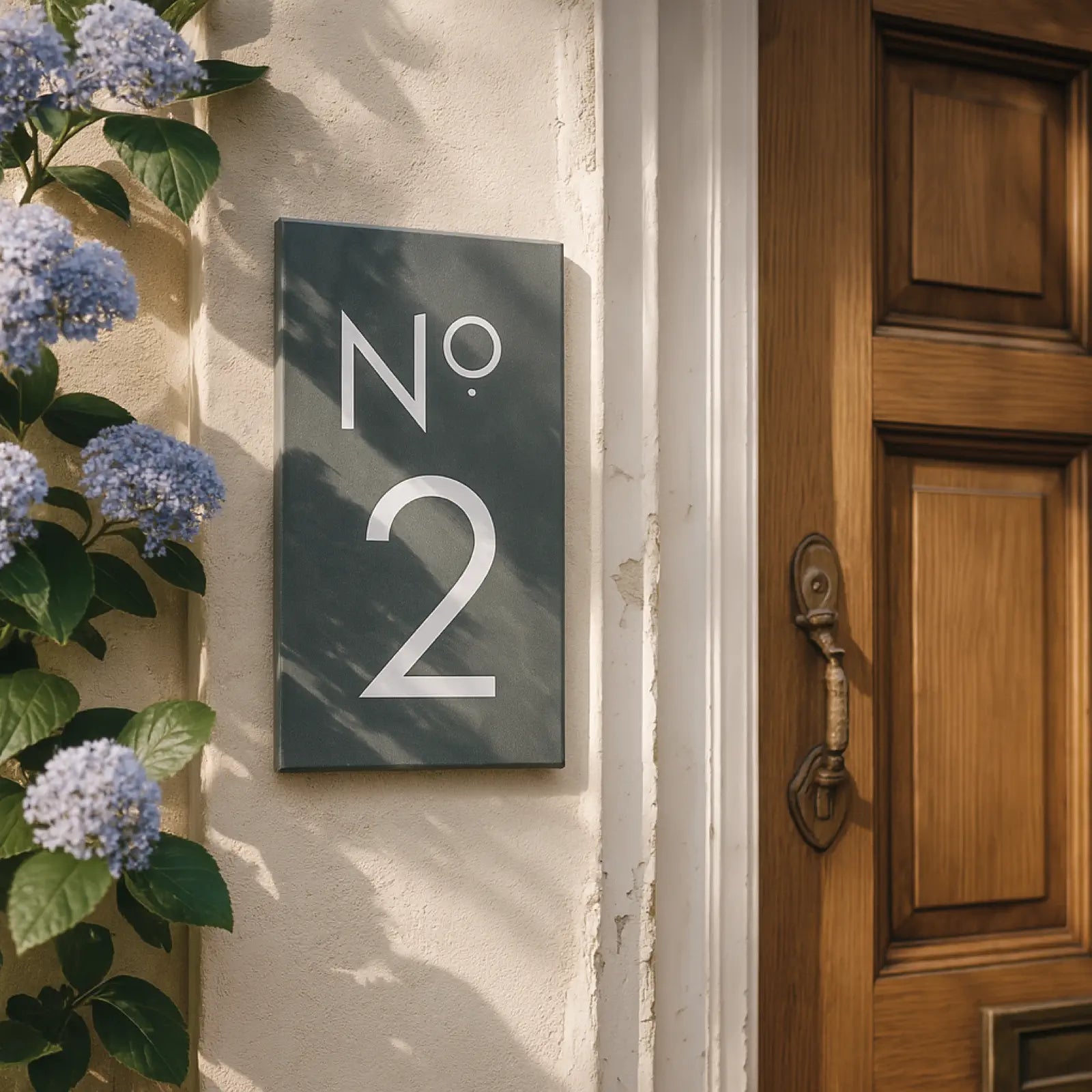 Number '2' sign on a wooden stand with red foliage in the background