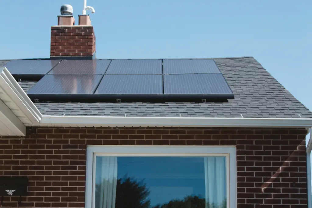 7 dark blue solar panels on a red brick bungalow