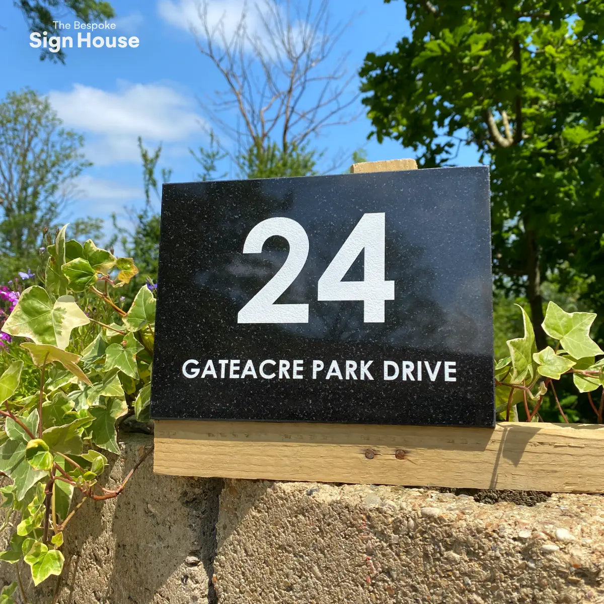 black granite house sign with engraved and painted white text that says 24 Gateacre Park Drive