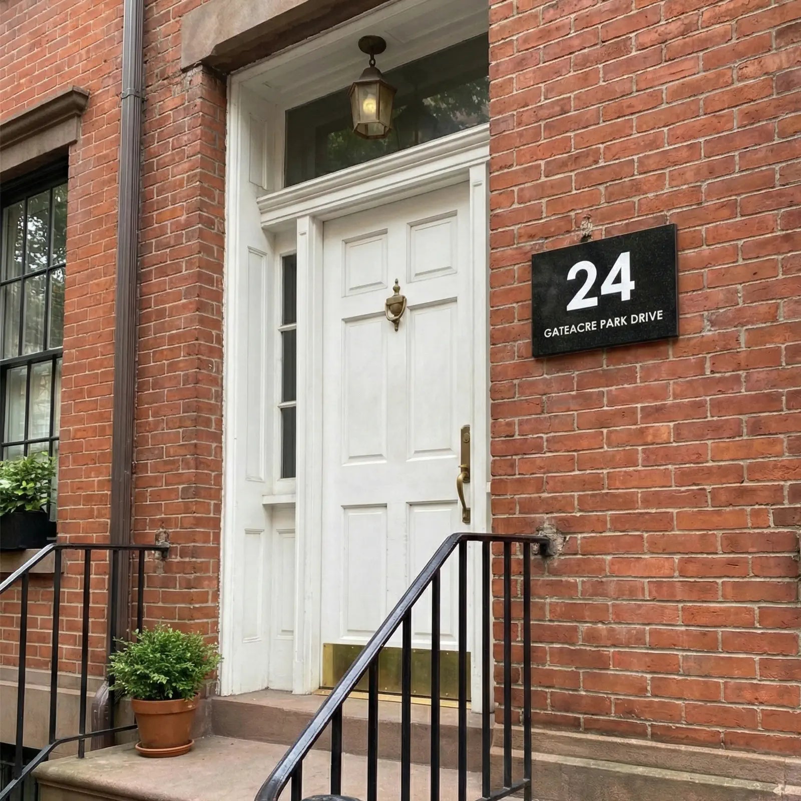 Brick building with a white door and address sign '24 Gateacre Park Drive'.