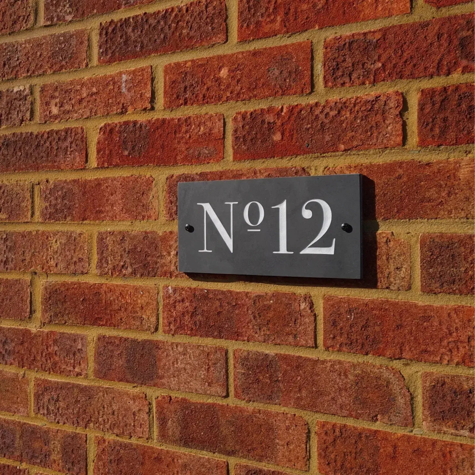 door number sign in white times new roman lettering