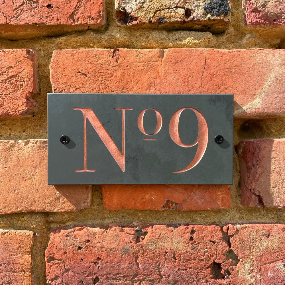 House number sign with copper paint infill
