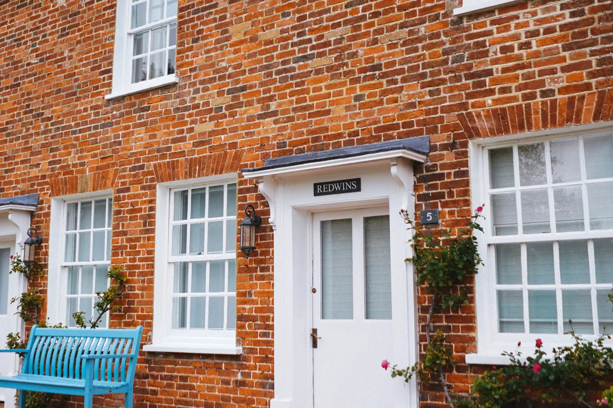 A stylish home with a house sign and door number