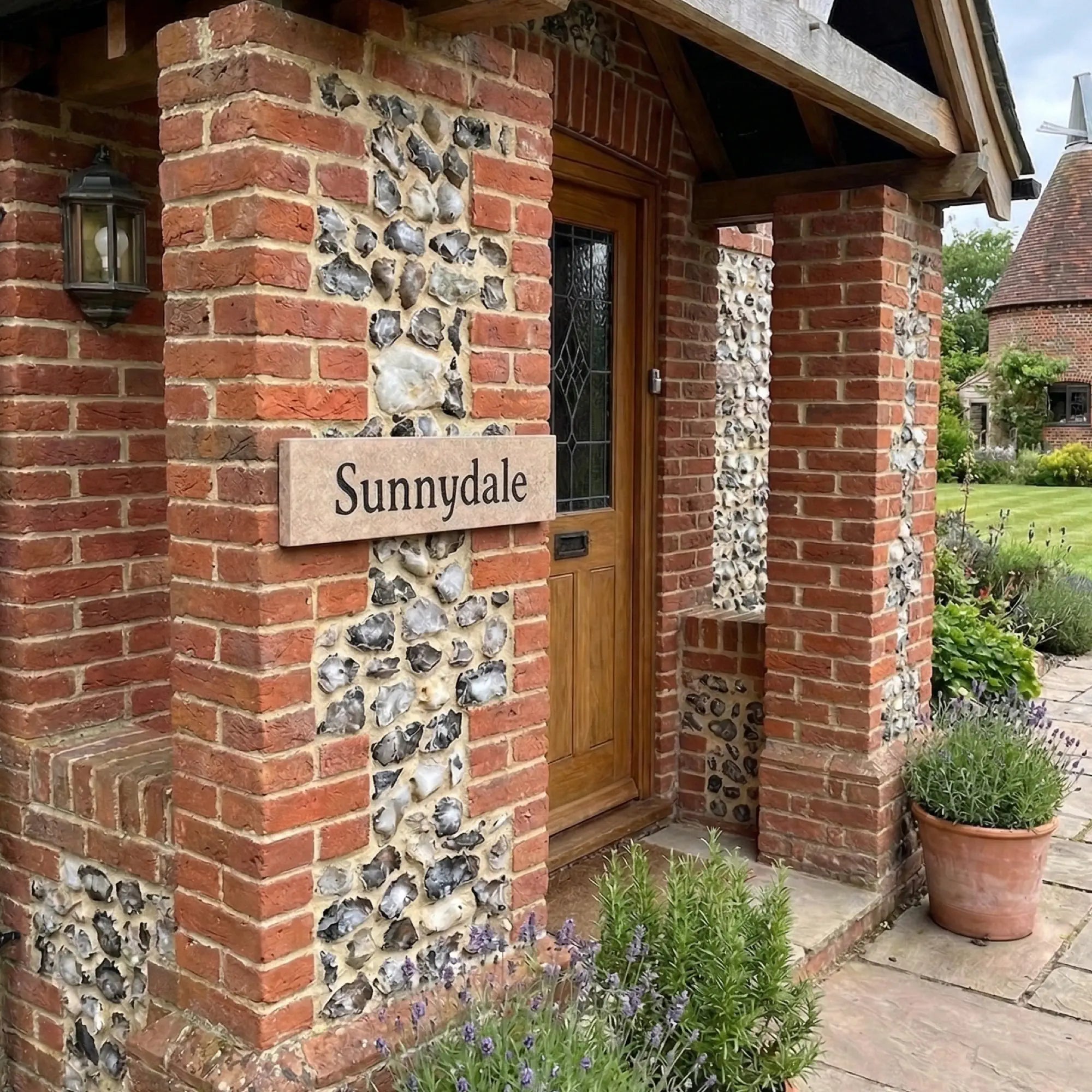 a limestone sign on a brick wall reading Sunnydale in black