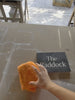 orange cloth cleaning grey slate sign