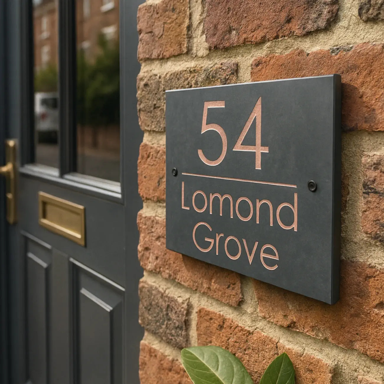 House number sign '54 Lomond Grove' on a brick wall, with 'The Sign House' branding.