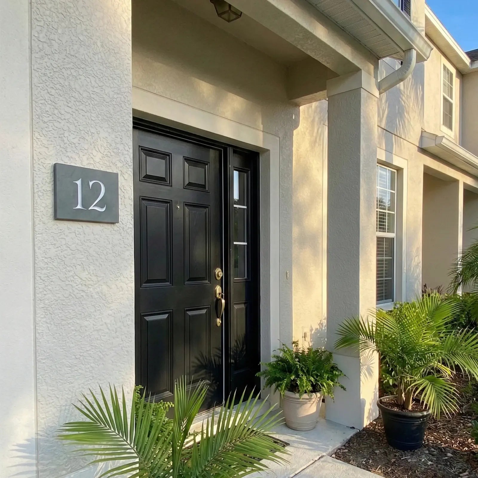 House exterior with a black door and house number 12