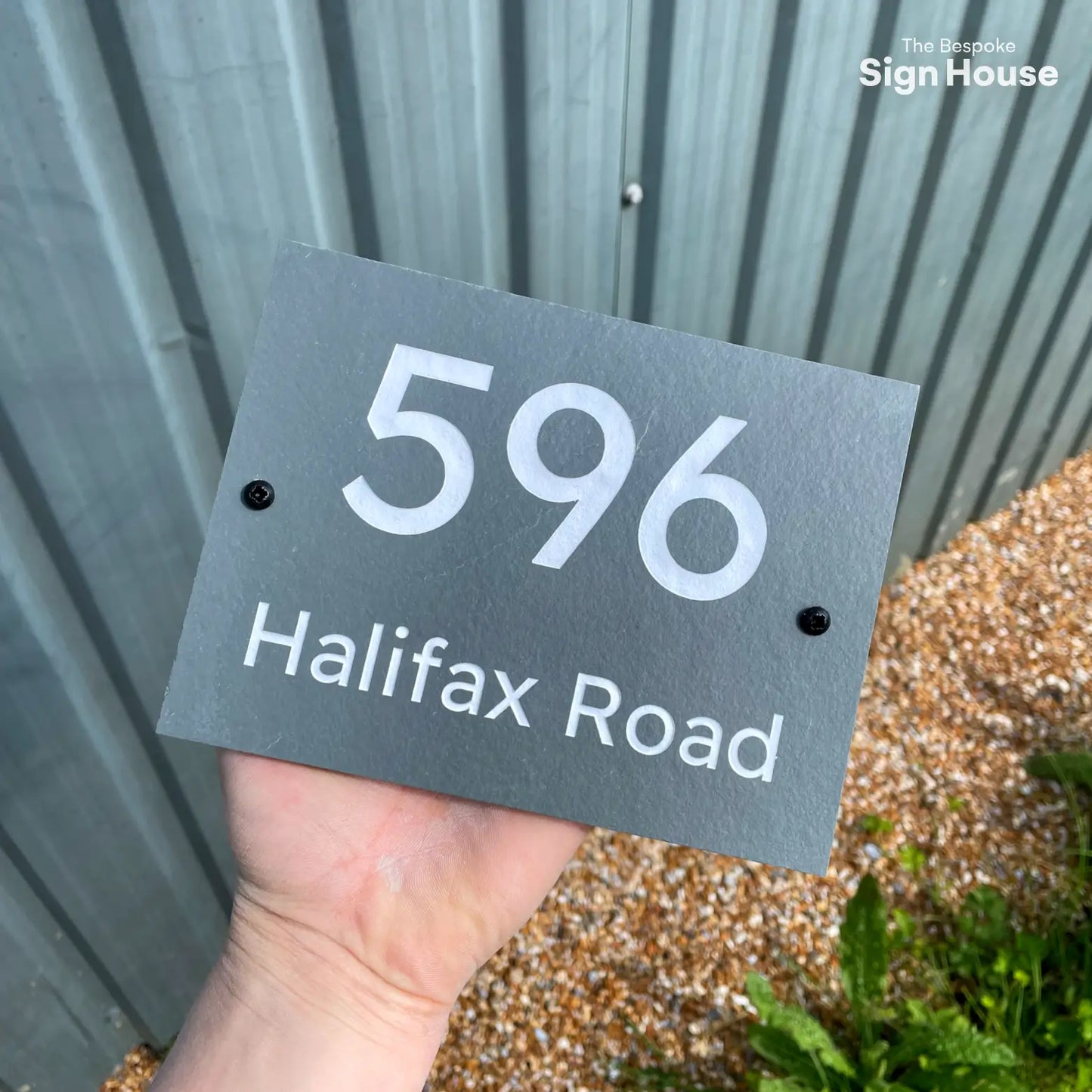 a slate house sign with number and street name engraved in silver