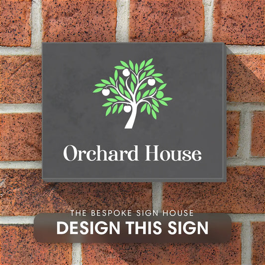 A preview of a slate house sign with a tree and house name, fixed onto a brick wall of a house.