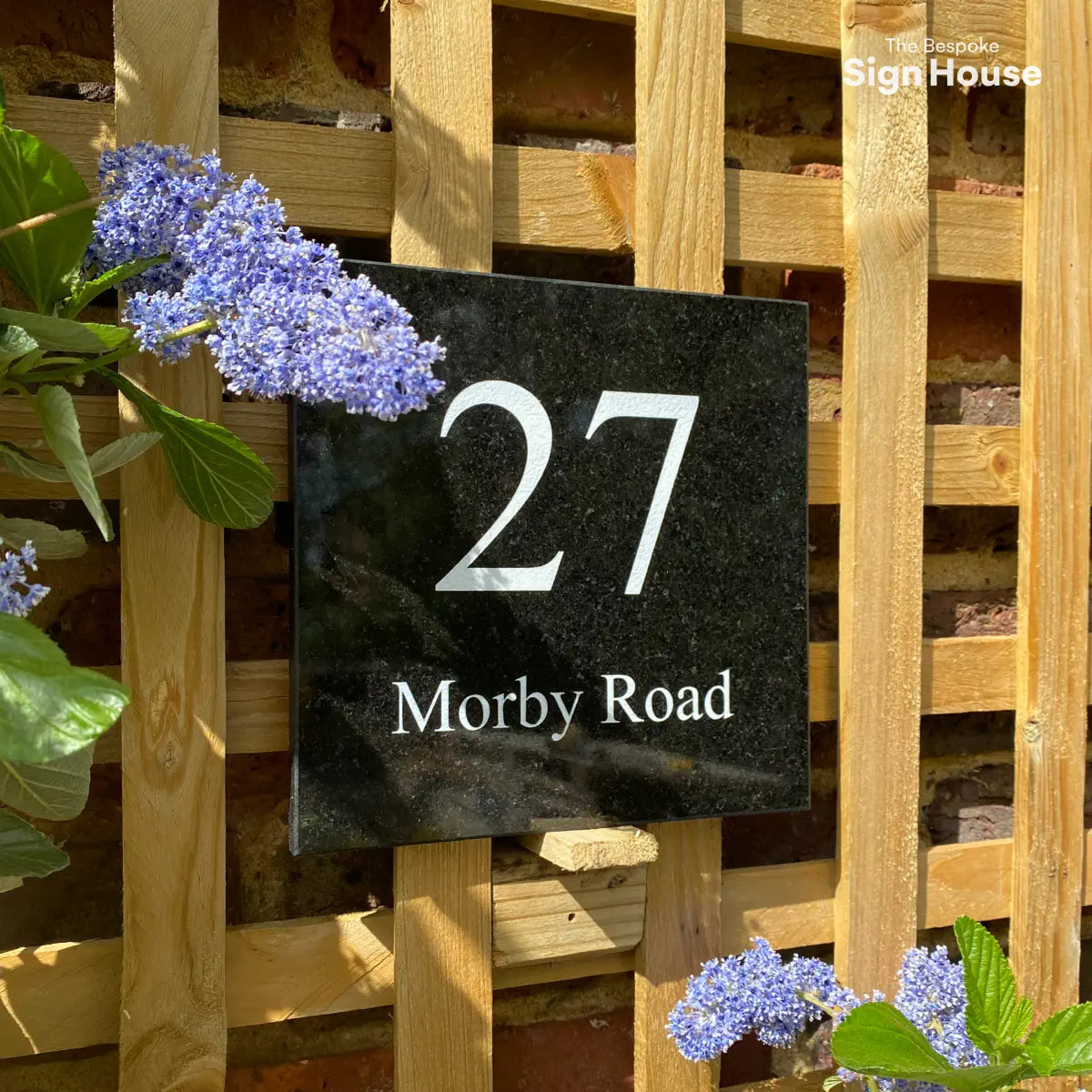 square granite sign with white 27 and road name called Morbys Road