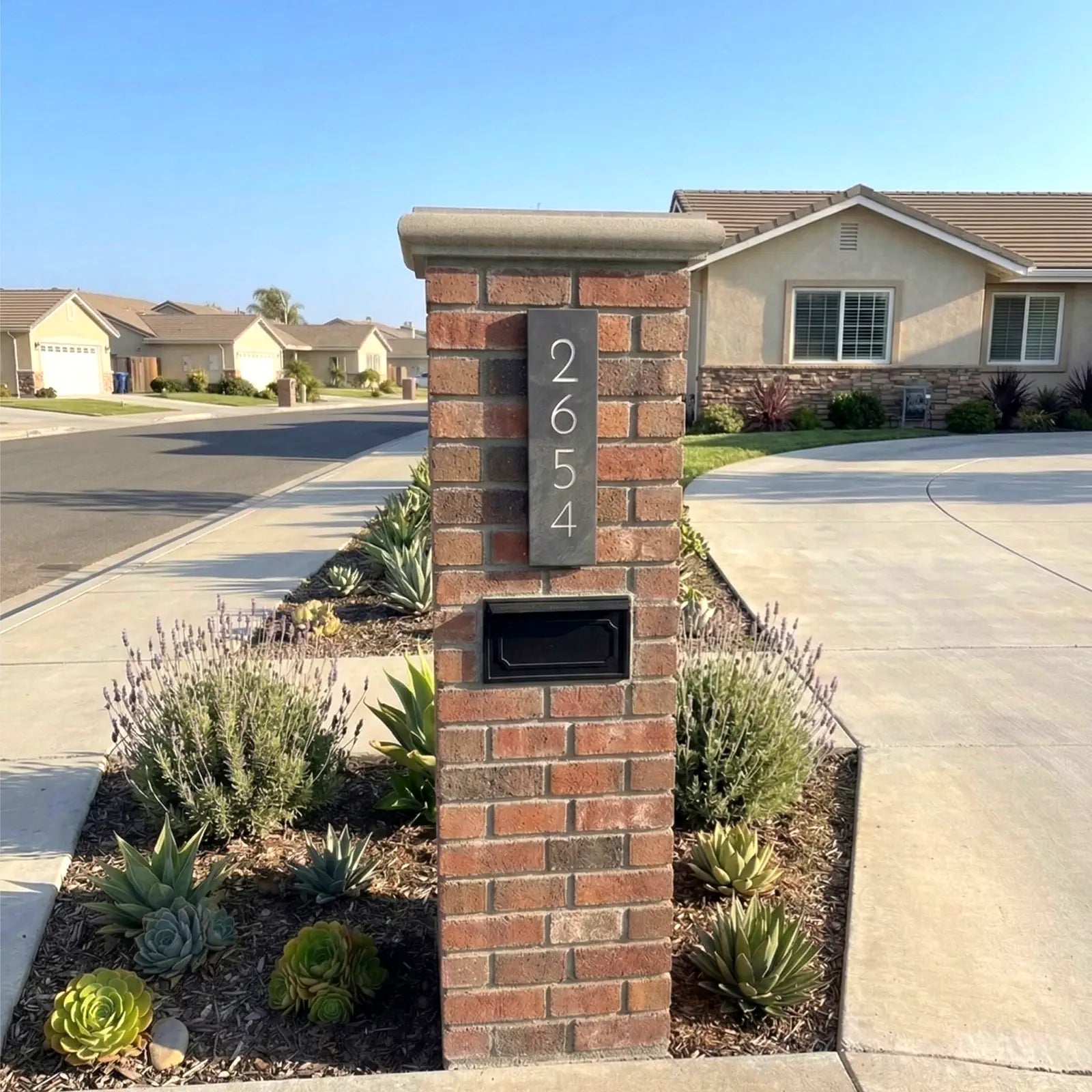 Brick mailbox with house number 2654 in a suburban neighborhood.