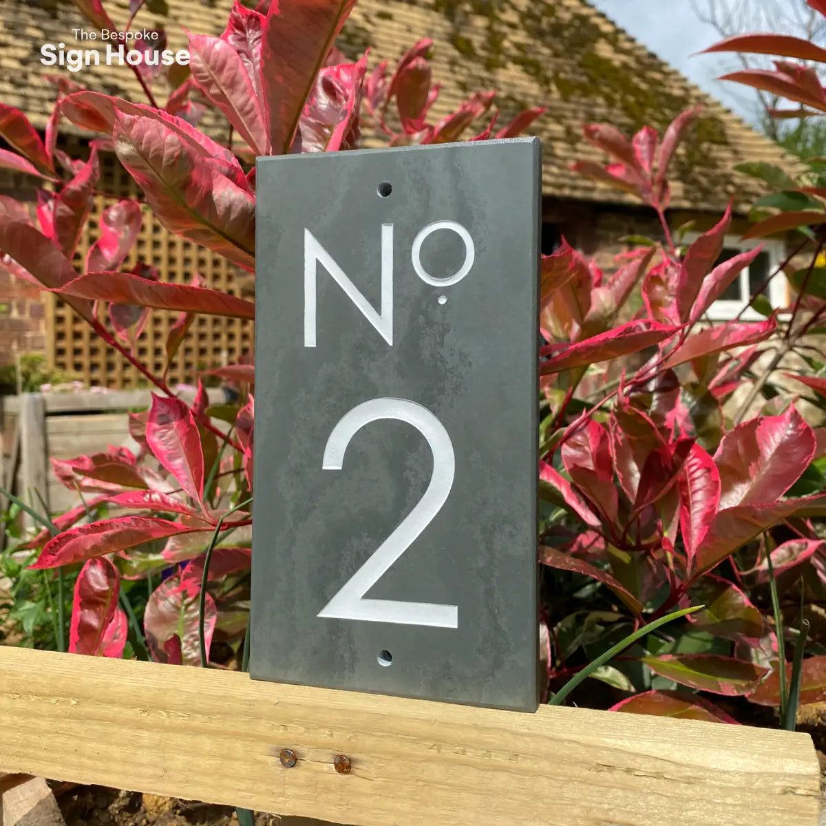 vertical slate house sign with white number 2