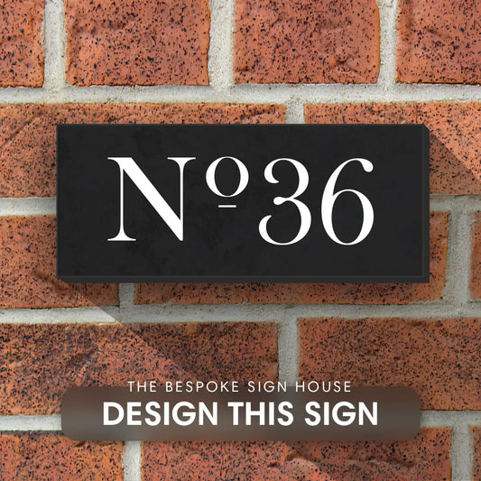 granite house sign with house number engraved and paint white in a traditional, cursive font